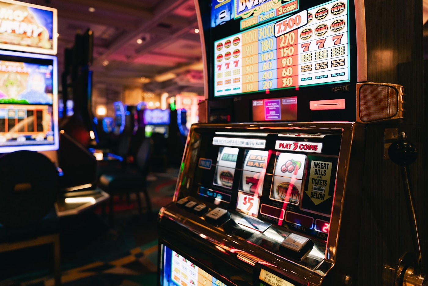 A gaming machine glowing in a dimly lit hall.