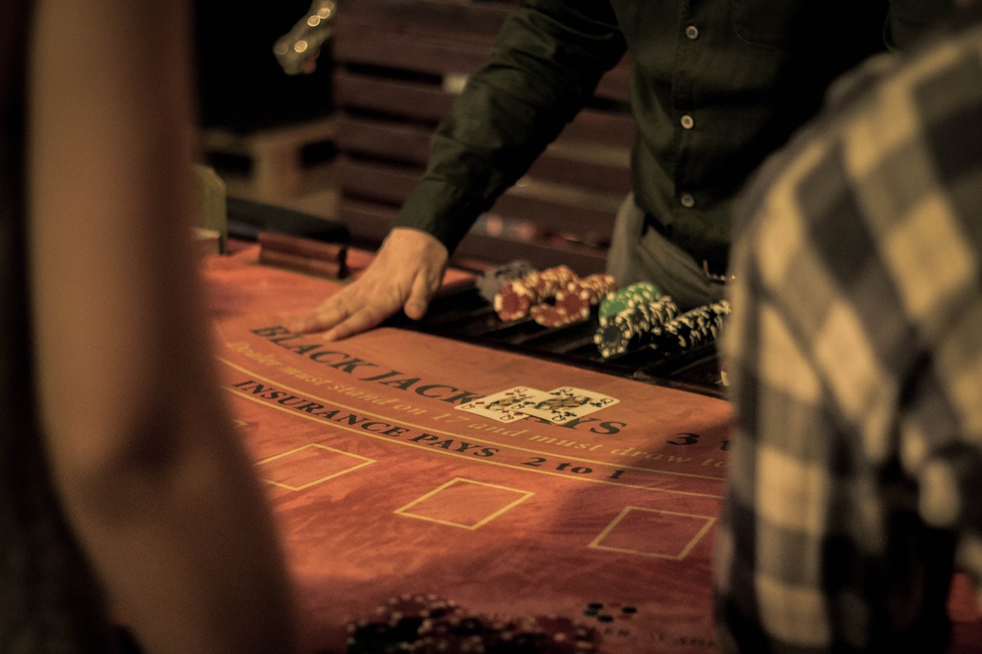 A dealer setting out chips on a blackjack table.